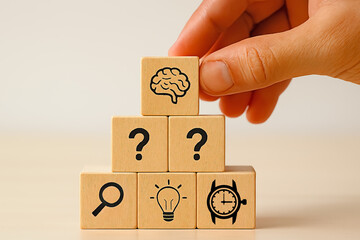 hand holding a wooden cube  Cognitive Insight Pyramid &ndash; Wooden Blocks with Brain, Research, Idea, Time, and Question Icons
