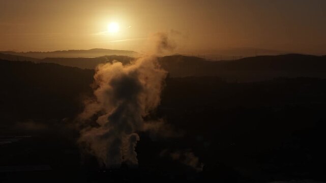Factory vapor plume in silhouette