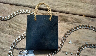 Black Shopping Bag with White Flowers on Moss Background &ndash; Natural Decorative Still Life