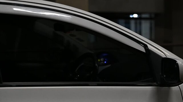 Car front door electric window opening and closing, creating a smooth motor whirring and glass sliding sound.