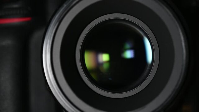 DSLR camera lens performing autofocus, creating a rapid, quiet motor whirring and slight clicking sound.