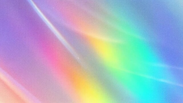 Abstract colorful rainbow gradient background with soft light reflections.