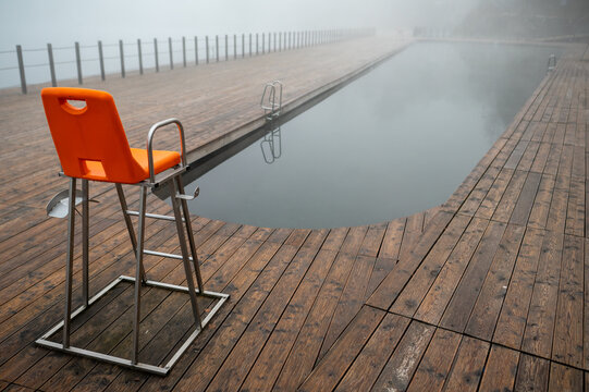 Foggy Poolside with Empty Lifeguard Chair