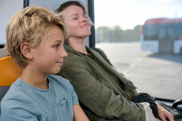 Mother and son traveling by bus relaxing