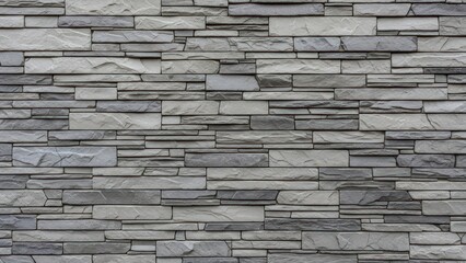 Irregularly stacked grey and white stone wall texture, horizontal pattern
