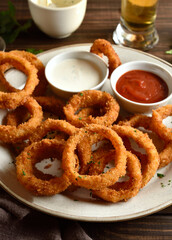 Fried breaded onion rings served with sauce