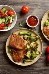 Juicy grilled pork steak served with roasted broccoli