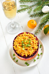 Christmas layered vegetable salad with herring and boiled vegetables