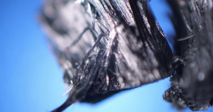 Zinc (Zn) Pieces Close Up Under Microscope Blue Background, Torn Metallic Texture And Shiny Fibers, Metallurgy Material Science Research, Detailed Mineral Surface Analysis, Engineering Concept