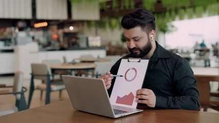 Portrait of bearded Indian data analytics expert shows infographic to partners at online meeting in office. Financial professional reports of achievement using charts on video call - Powered by Adobe