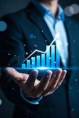 Businessman holding a glowing blue financial growth chart in his hand