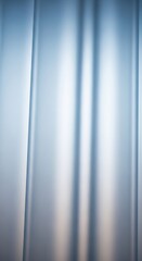 Soft blue and white abstract background with vertical light streaks and subtle folds