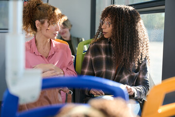 Women conversing during bus commute journey