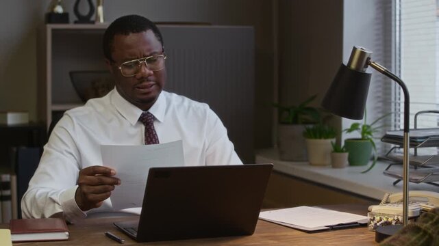Zoom out shot of teenage frustrated girl sitting silently while her mother and male principal discussing poor academic marks in school office