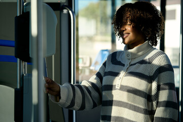 Woman paying for bus fare using transport validator