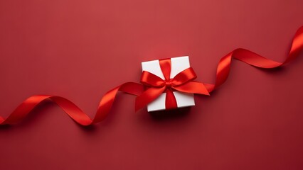 Elegant white gift box with red ribbon on a crimson background