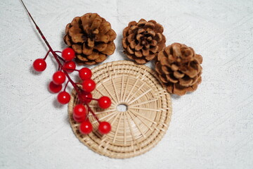 Natural Pinecones and Red Berries Arrangement on a Rustic Placemats for Seasonal Decoration and Craft Use in Festive Settings