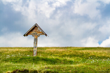 Jesus on the cross.  A traditional Orthodox cross in a mountain meadow. Parang Mountains, Southern Carpathians, Romania 