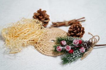 Festive Arrangement with Natural Elements and Decorations for Holiday Celebrations Featuring Pinecones, Twigs, and Frosted Berries