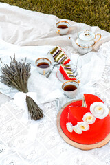 Red mousse cake with white flowers on a table