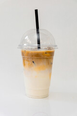 Cold latte coffee on a white background in a plastic cup