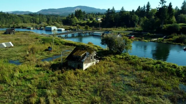 US, OR, Svenson, 2025-10-21 - Drone view of sunken and abandoned housees on an offshoot of the Columbia River near Astoria, Oregon in Fall