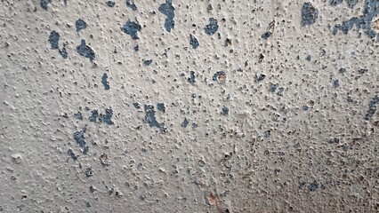 Old wall texture with peeling paint, uneven bumps and weathered surface details perfect for grunge backgrounds, aging effects and design projects on white background