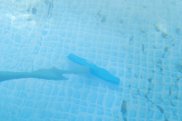 Fototapeta premium framed pool brushing on sunny. Contaminated pool cleaning concept