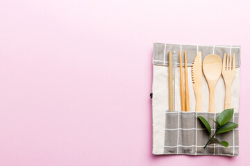 Eco friendly reusable recyclable white eco bag with kitchenware on Colored background. Concept zero...