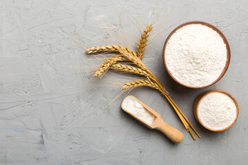 Flat lay of Wheat flour in wooden bowl with wheat spikelets on colored background. world wheat crisis
