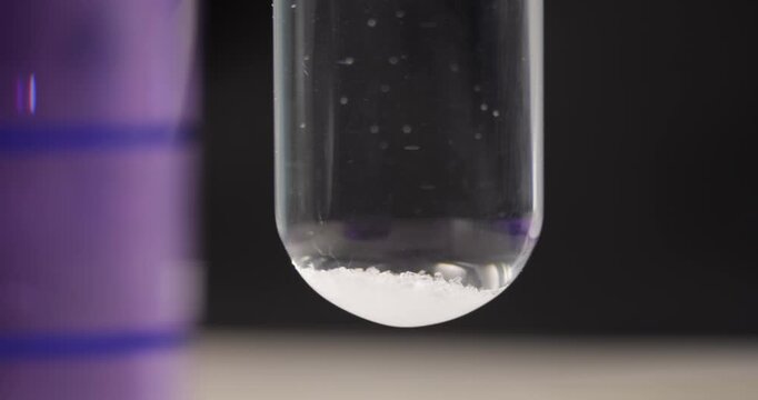 Phenolphthalein (C20H14O4) Indicator Added to Glass Test Tube, Chemical pH Level Reaction Test, Scientific Laboratory Experiment, Liquid Color Change Process, Research and Education Discovery