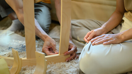 Closeup young couple assembly a new furniture at home