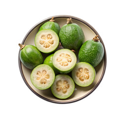 Acca sellowiana: whole and cut feijoa fruits in ceramic bowl.