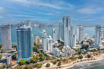 Obraz premium Aerial drone view of Cartagena Bocagrande high rise residential towers with Caribbean bay and cargo port in background