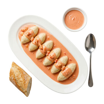 Appetizing gourmet French cuisine, Quenelles de Brochet with Sauce Nantua. classic pike dumpling dish on platter