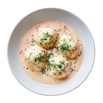 Appetizing Quenelles de Brochet with Sauce Nantua. Gourmet French pike fish dumplings in classic creamy sauce
