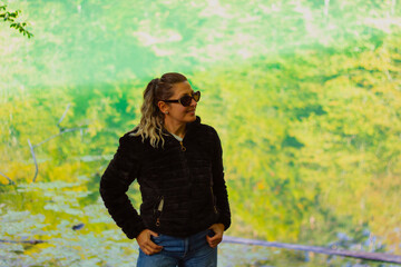 portrait of young beautiful woman near the lake in Autumn