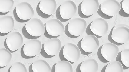 Overhead view of numerous small white fresh cheese balls arranged on a white surface, creating a minimalist and appealing culinary pattern perfect for ingredient displays