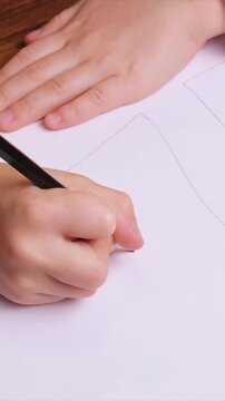 Top view of young kid carefully tracing straight lines for castle gate and towers, minimalistic unfinished drawing with copy space, useful for childrens coloring pages, school materials