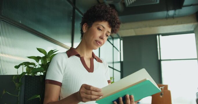 black woman creative director studying teal brand guide