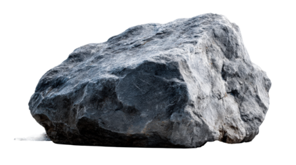 Massive dark gray boulder with rough textured surface resting on loose stones and sand, suitable for natural resource and geological themes