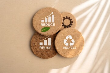 Sustainable living concept showing reduce reuse recycle on round cork coasters