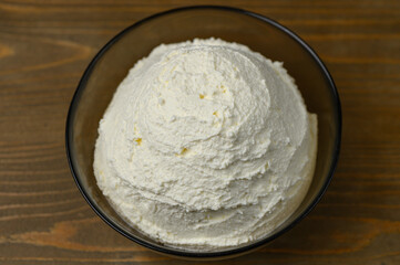 Bowl of Homemade Cottage Cheese on a Light Wooden Tabletop. Scandinavian Minimalism.