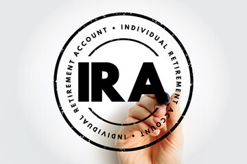 IRA Individual Retirement Account text in circular stamp with hand holding marker, financial concept image for retirement savings, investment, and planning