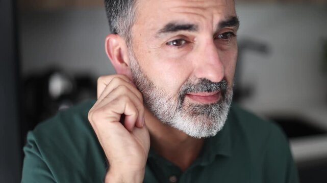 Mature man experiencing hearing loss and tinnitus