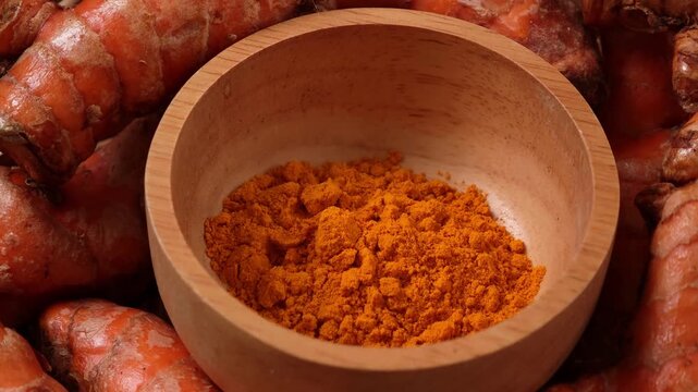 Turmeric powder in a wooden cup