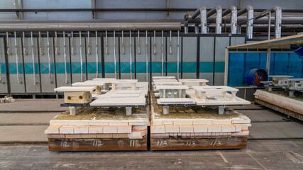 Ceramic toilet semi-finished products waiting to be fired on the shelf