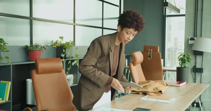 black woman retrieving materials from bag before meeting