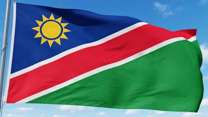 Waving Namibian flag against a clear sky, symbolizes national pride and identity, country
