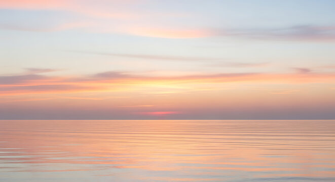 Serene blurred pastel horizon with calm ocean reflecting a soft, dreamlike sky at sunrise or sunset - Powered by Adobe